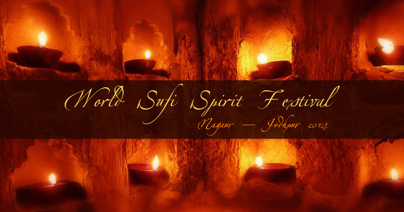 Sullo sfondo nicchie illuminante da lumini a olio, IN primo piano la scritta World SUfi Spiritual Fest