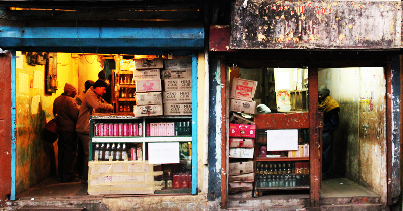 due piccole botteghe fatiscenti che vendono alcolici in india